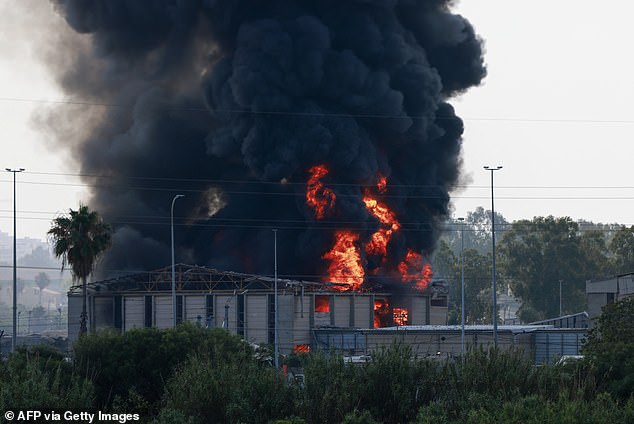 Smoke billows into the sky above Herzliya, near Tel Aviv, following a fresh barrage of Iranian rockets on Israeli targets