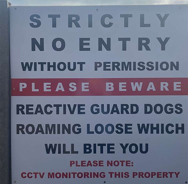 Pictured is a sign installed a the new traveller camp in Burley, which warned of 'dogs roaming loose which will bite you'