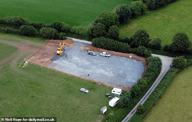 A field in a rural patch of north Devon countryside has been ripped apart by bulldozers and turned into a suspected traveller camp (pictured on Wednesday)