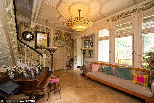The grand living room, complete with a piano, inside the island home