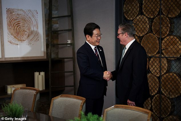 Starmer and South Korean President Lee Jae-myung shake hands as they meet for a bilateral meeting during the G7 Leaders' Summit on June 17
