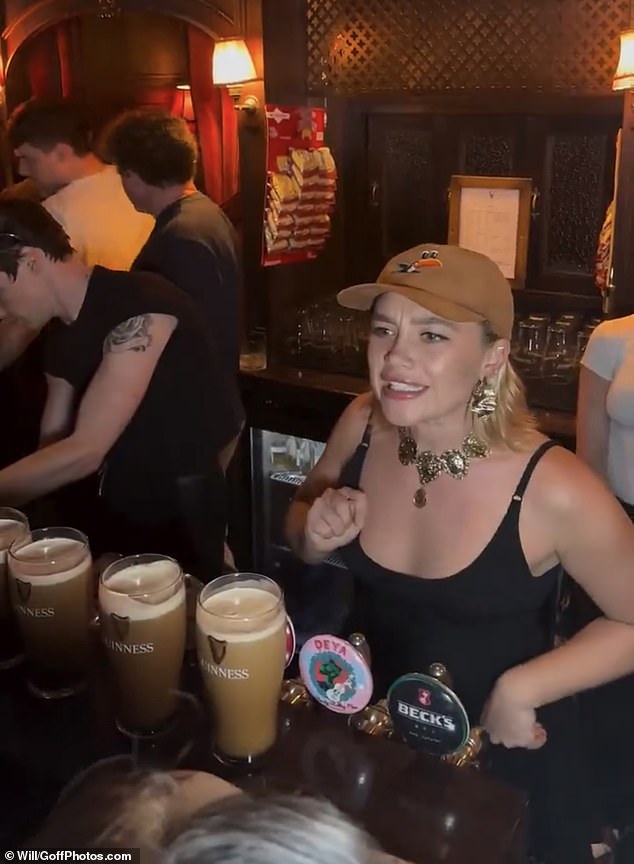 Florence Pugh, 29, pours pints for customers at the Devonshire Pub in Soho, London