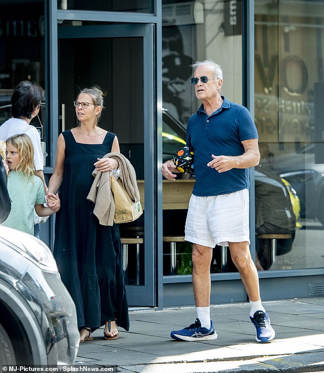 Kayte held their son's hand as they emerged from the store