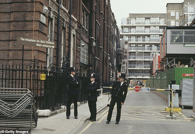 Police officers pictured on Powis Place near London's famous children's hospital