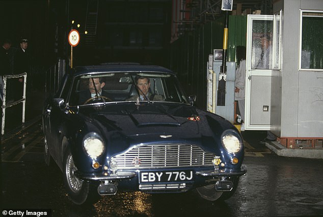 Prince Charles leaves Great Ormond Street Hospital in his vintage blue Aston Martin
