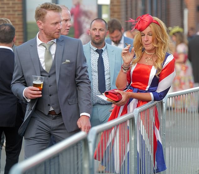 One man rocking a three piece suit whilst enjoying a pint whilst another racegoer was seen embracing her British pride with a Union Jack dress.
