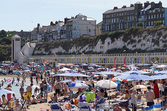 The Met Office predicts that heatwaves in which the UK spends 12 days above 35°C (95°F) are now possible. Pictured: Crowds enjoying the warm weather at Broadstairs, Kent during the 2022 heatwave