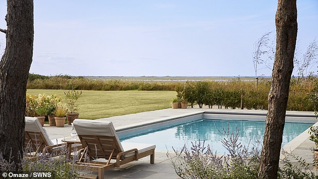 Sun loungers by the outdoor pool give a view over spectacular scenery by the north Norfolk coastline