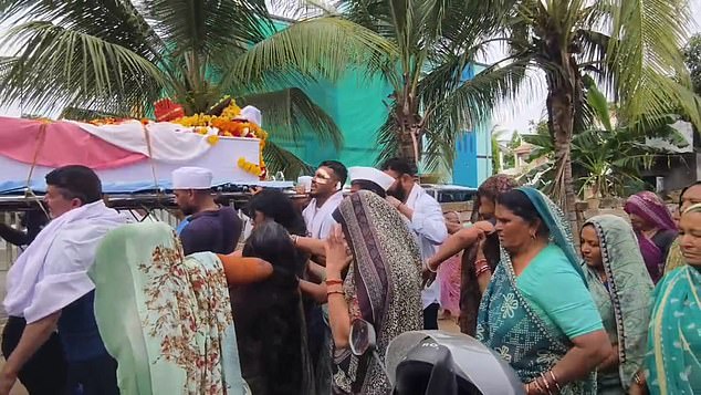 Ajay's coffin was adorned with colourful flowers, and was carried by several mourners, including his brother Vishwash