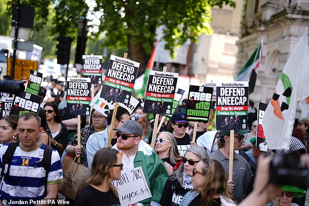 People hold placards supporting Og O Hannaidh outside Westminster Magistrates' Court today
