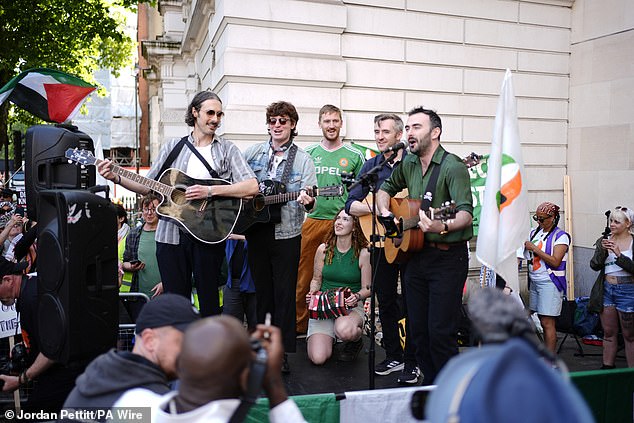 Musicians perform among supporters of Kneecap's Liam Og O Hannaidh outside court today