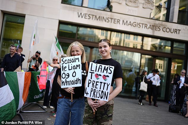 Supporters of Kneecap's Og O Hannaidh holds signs including 'Liam's Too Pretty 4 Prison'