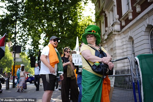 Demonstrators gather to show their support outside the court in Central London today