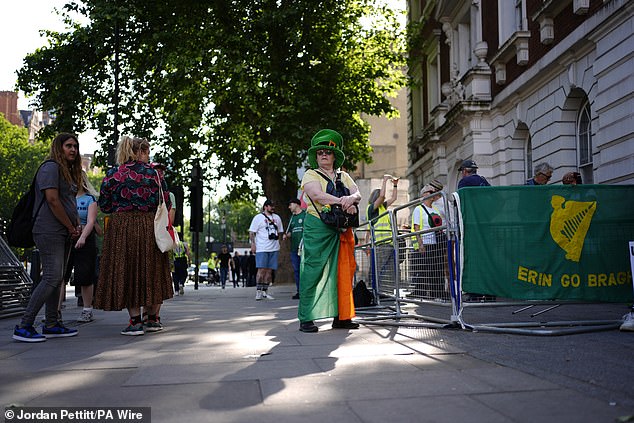 Demonstrators gather to show their support outside the court in Central London today