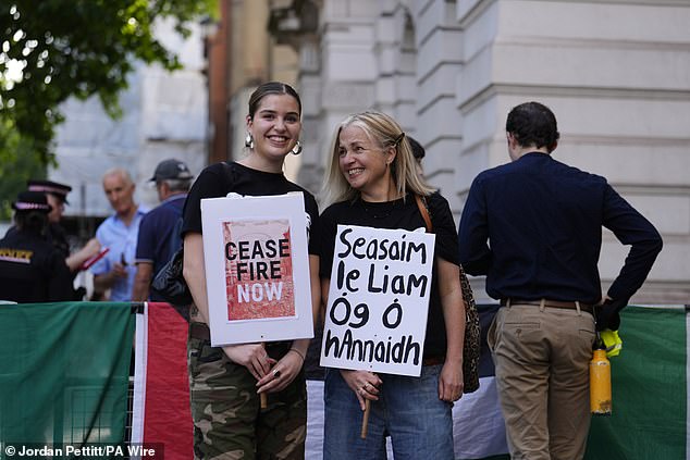 Demonstrators gather to show their support outside the court in Central London today