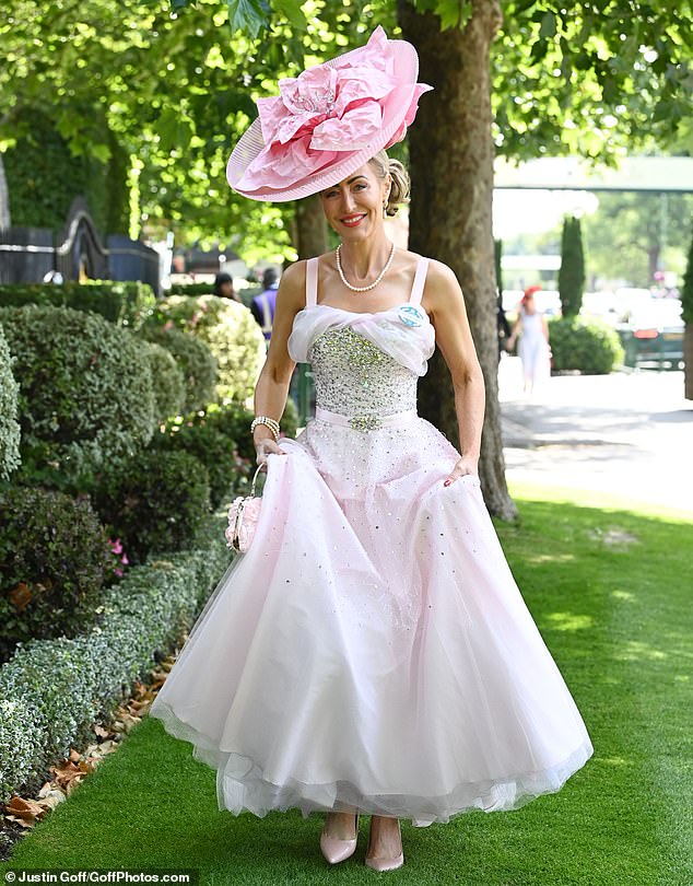 Glamorous: This stylish lady commanded attention in a billowing, shimmering dress and a statement hat