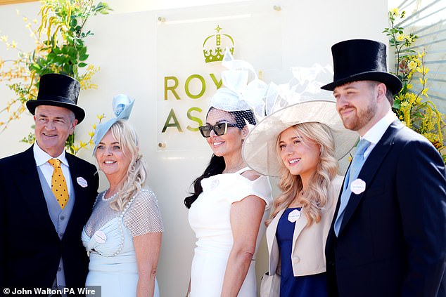 Strike a pose! A group of racegoers smile for the camera as they take a photo at Royal Ascot