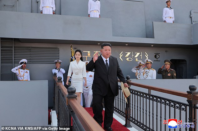 North Korea's leader Kim Jong Un (C) and daughter Ju Ae (center L) boarding the destroyer 'Kang Kon'