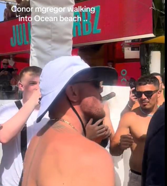McGregor puffed on a cigar and was surrounded by security upon entering Ocean Beach