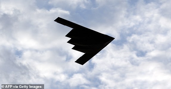 (FILES) A B-2 Stealth Bomber flies over the Washington Monument at the National Mall, during the Independence Day celebrations in Washington DC on July 4, 2020. A powerful American bunker-buster bomb, the only one capable of destroying Iran's deeply buried nuclear facilities, is Donald Trump's strategic weapon of choice should he decide to engage the US in conflict alongside Israel. The GBU-57, a 13-ton warhead capable of sinking dozens of meters before exploding, is all Israel needs to achieve its first war goal: blocking Teheran's construction of an atomic bomb. (Photo by Jose Luis Magana / AFP) (Photo by JOSE LUIS MAGANA/AFP via Getty Images)