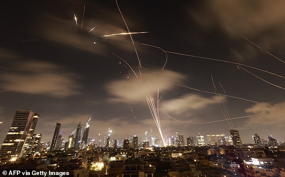TOPSHOT - Israeli air defence systems are activated to intercept Iranian missiles over the Israeli city of Tel Aviv early on June 18, 2025. Israel and Iran exchanged fire again on June 17, the fifth day of strikes in their most intense confrontation in history, fuelling fears of a drawn-out conflict that could engulf the Middle East. (Photo by Menahem Kahana / AFP) (Photo by MENAHEM KAHANA/AFP via Getty Images)