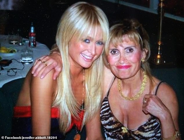 Ms Abbott pictured here with Paris Hilton wearing the Rolex that has been taken from her home