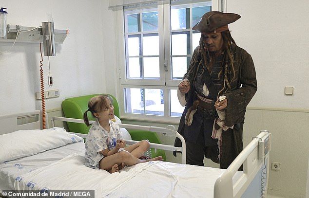 One little girl can be seen above smiling as she spoke to Depp from her hospital bed