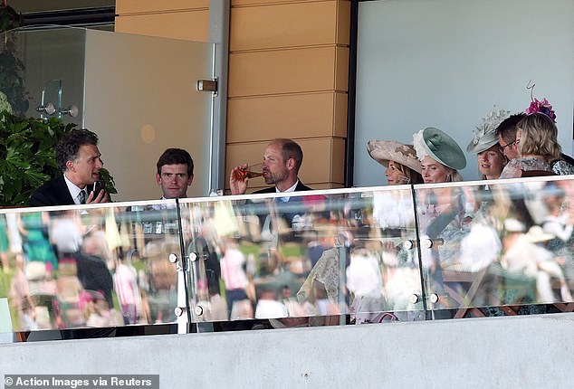 Enjoying the racing action! The Prince of Wales in the stands during the races