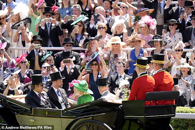 The excited crowd at Royal Ascot trying to get a photo of the royals