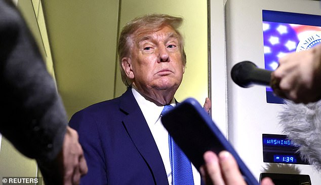 Donald Trump speaks to reporters aboard Air Force One after departing early from the the G7 summit in Canada to return to Washington on June 17
