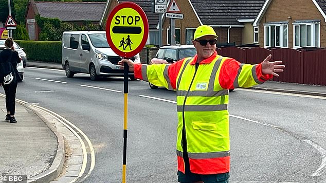 The stunned lollipop man took to social media to share the bizarre order, telling parents and supporters: 'I have been instructed that I can no longer high-five children any more whilst crossing the road'