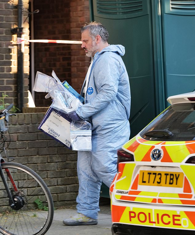 Forensics officers were seen carrying several bags of miscellaneous items from the victim's flat on Wednesday evening.
