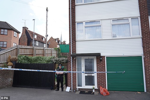 Police guard the McCullough's house in Great Baddow, Chelmsford after their bodies were found inside