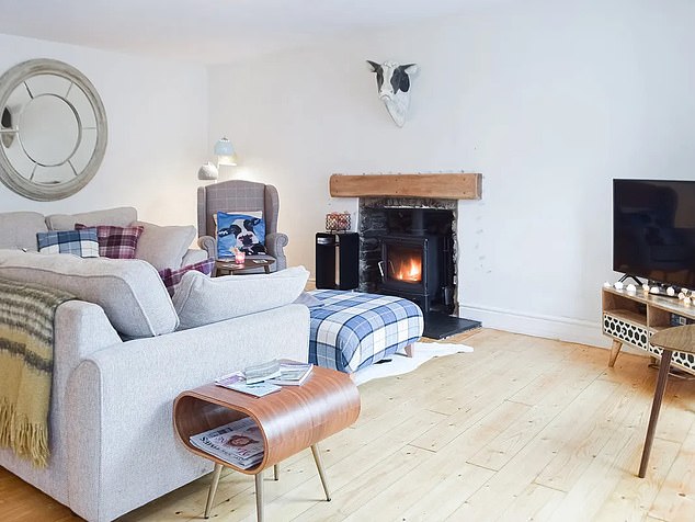 The cosy property boasts a log burning stove in the open plan lounge, which also includes an L-shaped sofa, dining table and television