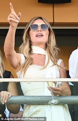 She beamed while watching on from the stands