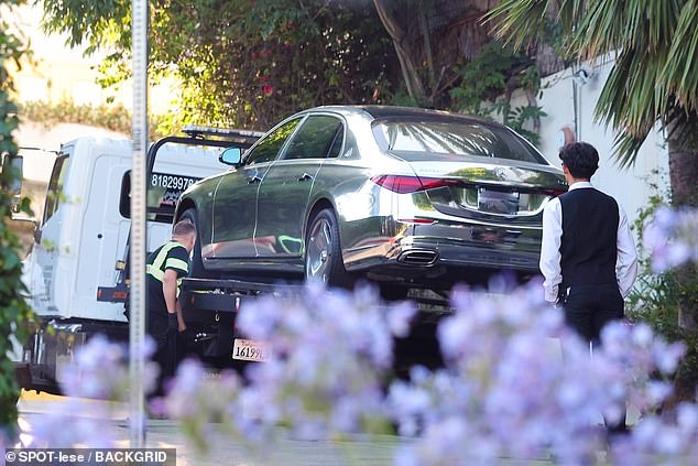 New images obtained by Daily Mail show the luxury car owned by the 48-year-old superstar being put on the back of a tow truck and hauled away from the hotel