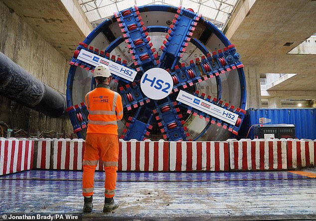 An HS2 worker stands in front of tunnel boring machine Karen at the Old Oak Common station box site during preparations for completing the 4.5 mile HS2 tunnelling to London Euston