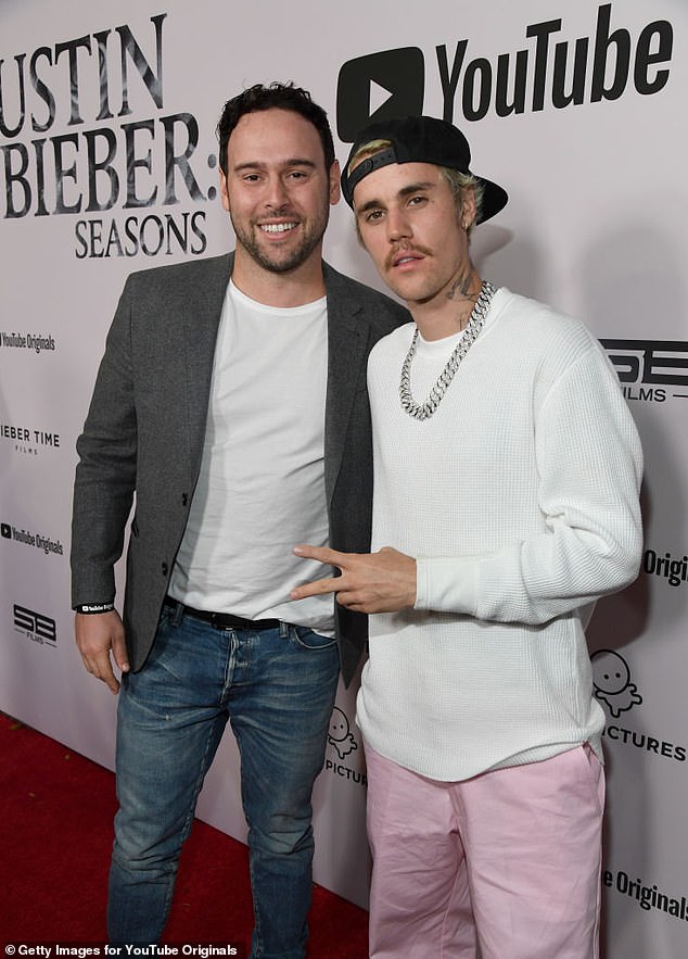 The 31-year-old pop superstar is said to be negotiating the terms of a settlement with Scooter Braun (L), and sources told TMZ on Tuesday that it could be hashed out within weeks; pictured in January 2020 in LA