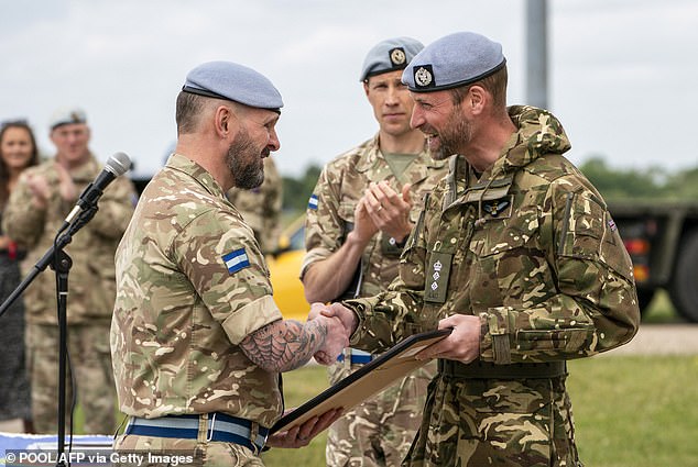 William shakes hands with members of the Army Air Corps in Wattisham. During his military career, the Prince of Wales proved he was happy to muck in with his fellow soldiers and help with the domestic duties
