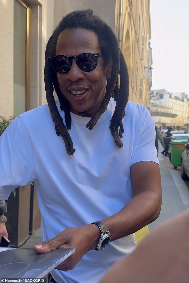 Jay-Z sported jeans and a white t-shirt with tan Timberland boots as he signed autographs outside the French luxury goods offices