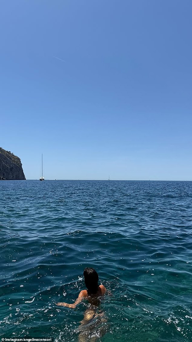 'My favourite spot,' Angelina captioned this photograph of herself taking a dip in the ocean in Mallorca, Spain
