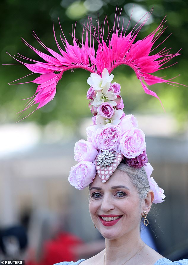 Hat's the spirit! This woman turned heads with an enormous floral themed headpiece