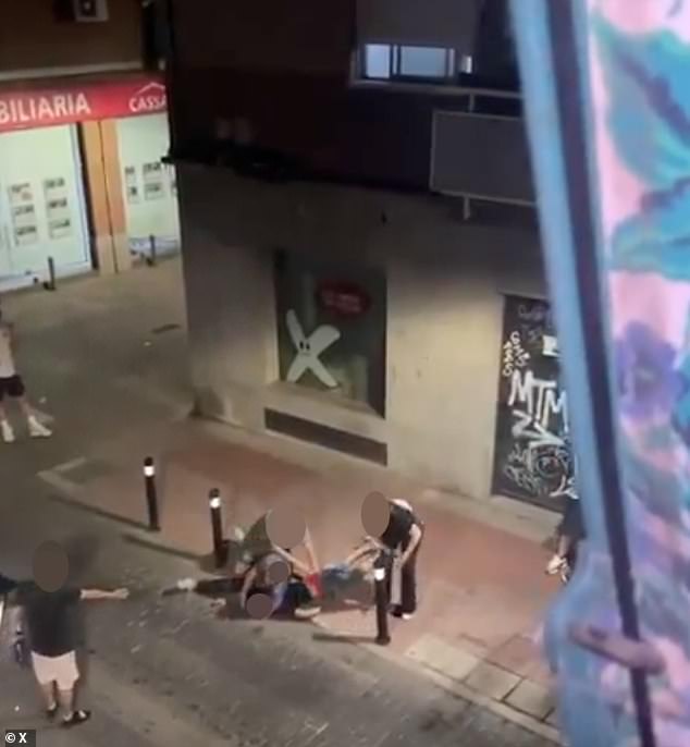 Passersby can be seen pleasing with the cop to let the man breathe