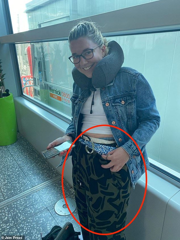 Dashing to the toilet for a quick outfit change, she soon emerged wearing two tops, a denim jacket - and seven pairs of trousers