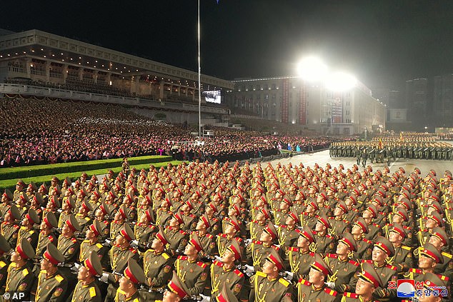Footage of the event on state television showed thousands of people - unmasked and not socially distanced - packed into Pyongyang's Kim Il Sung square to watch ranks of soldiers goose-step