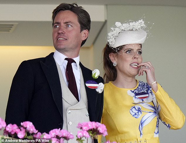 Princess Beatrice nervously looks down on the racing action next to her husband Edoardo