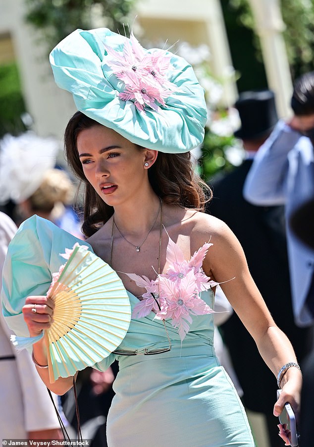 Old-school: The accessory of choice on the UK's hottest day so far was the traditional fan