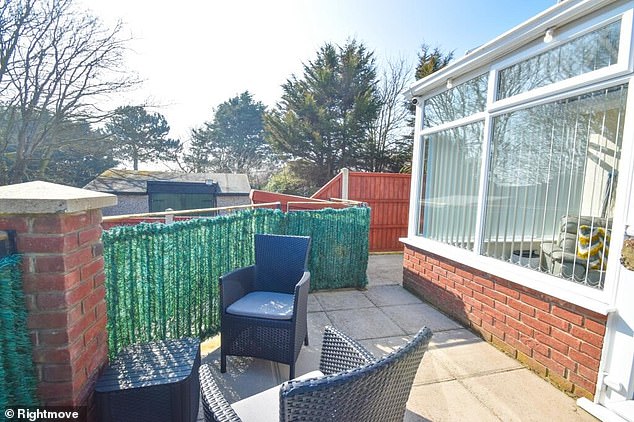 The raised patio area outside the conservatory
