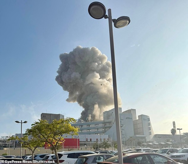 The dramatic developments came on another day of horror as an Iranian ballistic missile struck Soroka Hospital, in Beersheba, which suffered extensive damage. The attack, a direct hit, left 71 injured and saw prime minister Benjamin Netanyahu vowing revenge. Pictured: Smoke billows from a building at Soroka Hospital