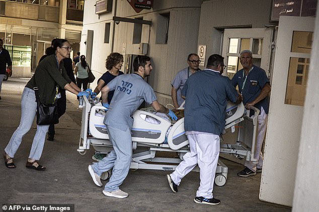 Doctors wheel a patient to safety after a building at Soroka Hospital was struck by an Iranian missile in Beersheba in southern Israel on June 19, 2025